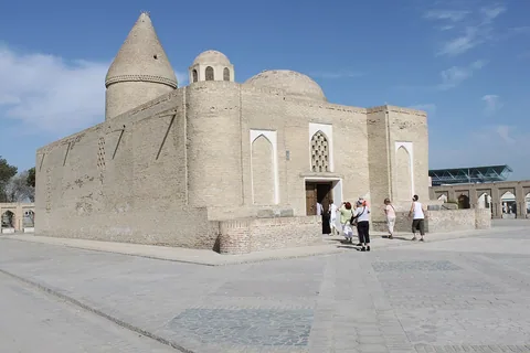 The city Chashma Ayub shrine in Bukhara, with its conical roof and adjoining rounded domes.