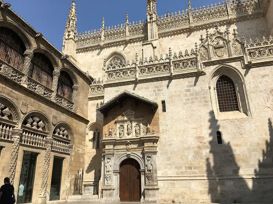 The decorated Gothic wall and entrance of Granada’s Royal Chapel, beside the adjoining arcaded Lonja.