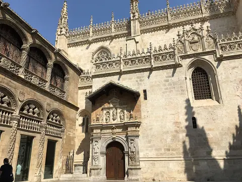 The decorated Gothic wall and entrance of Granada’s Royal Chapel, beside the adjoining arcaded Lonja.