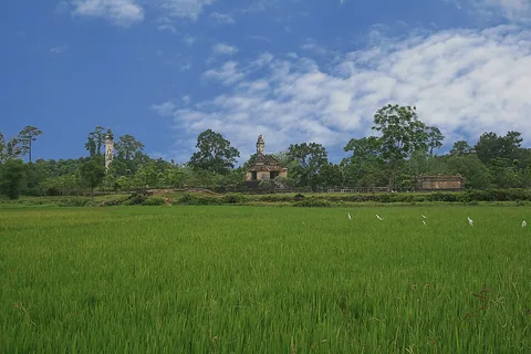 The Thiệu Trị tomb landscape beyond a green field