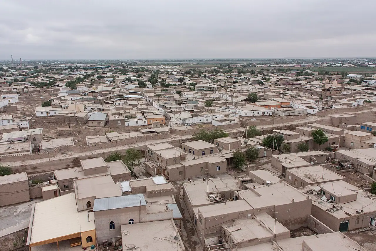 Khiva’s flat rooftops and narrow lanes seen from the height of Islam Khoja minaret, with the city stretching to the horizon.