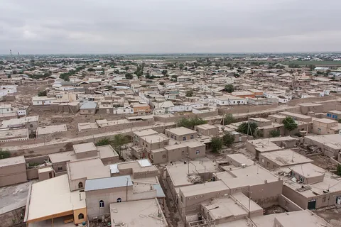 Khiva’s flat rooftops and narrow lanes seen from the height of Islam Khoja minaret, with the city stretching to the horizon.