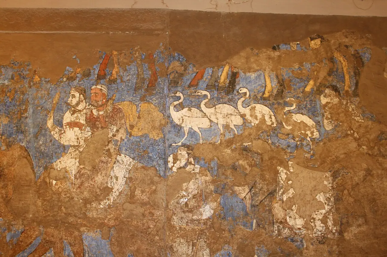 A worn seventh-century Afrasiab mural shows pale horses, a camel and figures in a ceremonial procession.