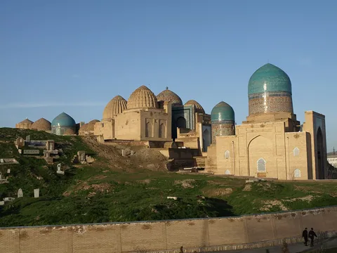 Brick mausoleums and blue domes of Shah-i Zinda rise above the surrounding cemetery.