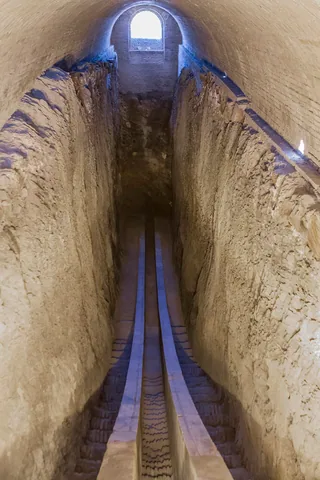 The surviving parallel stone arcs of Ulugh Beg’s measuring instrument descend into a deep excavated trench.