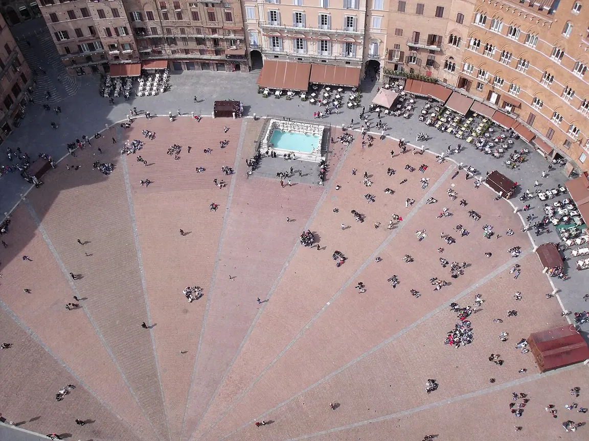 Elevated view across Piazza del Campo showing the shell-shaped brick paving and pale dividing bands