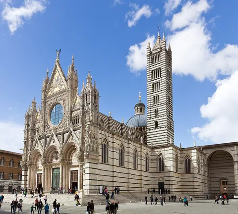 Siena Cathedral's marble facade and striped bell tower seen across Piazza del Duomo