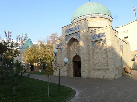The brick façade and rounded dome of the Sheikh Hovendi at-Tahur mausoleum in Tashkent.